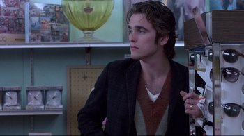 Movie still from “Drugstore Cowboy” (1989), directed by Gus Van Sant – A young man in a jacket and sweater looking up; Medium shot, Over the shoulder angle