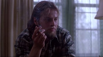 Movie still from “Drugstore Cowboy” (1989), directed by Gus Van Sant – A person smoking a cigarette; Close Up shot, Low angle