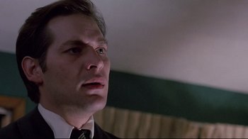 Movie still from “Drugstore Cowboy” (1989), directed by Gus Van Sant – A person wearing a suit and tie; Close Up shot, Low angle
