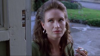 Movie still from “Drugstore Cowboy” (1989), directed by Gus Van Sant – A person with long brown hair; Close Up shot, Low angle