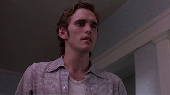 Movie still from “Drugstore Cowboy” (1989), directed by Gus Van Sant – A young man in a plaid shirt looking to his left; Close Up shot, Low angle