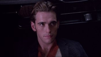 Movie still from “Drugstore Cowboy” (1989), directed by Gus Van Sant – A person wearing a suit and tie; Close Up shot, Over the shoulder angle