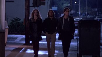 Movie still from “Drugstore Cowboy” (1989), directed by Gus Van Sant – A group of people walking down a street at night; Wide shot, Low angle