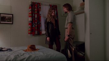 Movie still from “Drugstore Cowboy” (1989), directed by Gus Van Sant – A man and a woman standing next to each other in front of a bed; Medium shot, Low angle