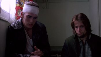 Movie still from “Drugstore Cowboy” (1989), directed by Gus Van Sant – A man with a bandage on his head and another man with a bandage on his head; Medium shot, Low angle