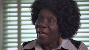 Movie still from “Drugstore Cowboy” (1989), directed by Gus Van Sant – An older black woman wearing a black and white polka dot shirt; Close Up shot, Low angle
