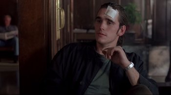 Movie still from “Drugstore Cowboy” (1989), directed by Gus Van Sant – A man with a bandage on his forehead; Close Up shot, Over the shoulder angle