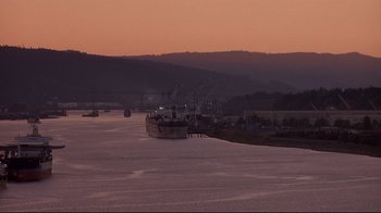 Movie still from “Drugstore Cowboy” (1989), directed by Gus Van Sant – Many boats in the water at dusk; Extreme Wide shot, Low angle