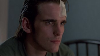 Movie still from “Drugstore Cowboy” (1989), directed by Gus Van Sant – A man with a bandage on his forehead; Close Up shot, Low angle
