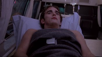 A man laying in a hospital bed looking up at the sky