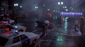 Movie still from “Drugstore Cowboy” (1989), directed by Gus Van Sant – Cars parked on a street in the rain at night; Extreme Wide shot, Low angle