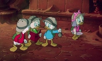 Movie still from “DuckTales the Movie: Treasure of the Lost Lamp” (1990), directed by Bob Hathcock – A group of cartoon characters standing next to each other on the ground; Medium shot, High angle