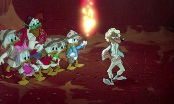 Movie still from “DuckTales the Movie: Treasure of the Lost Lamp” (1990), directed by Bob Hathcock – A group of cartoon characters standing in front of a light; Wide shot, High angle