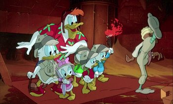 Movie still from “DuckTales the Movie: Treasure of the Lost Lamp” (1990), directed by Bob Hathcock – A group of cartoon characters are gathered together in a cave; Wide shot, High angle