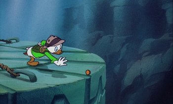 Movie still from “DuckTales the Movie: Treasure of the Lost Lamp” (1990), directed by Bob Hathcock – A cartoon of a duck with a hat on and a backpack on; Wide shot, Overhead angle