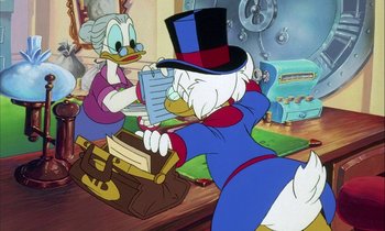 Movie still from “DuckTales the Movie: Treasure of the Lost Lamp” (1990), directed by Bob Hathcock – Two cartoon characters are playing a video game together; Medium shot, Over the shoulder angle