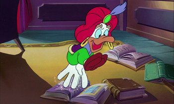 Movie still from “DuckTales the Movie: Treasure of the Lost Lamp” (1990), directed by Bob Hathcock – A cartoon of a duck standing on a pile of books; Medium shot, High angle