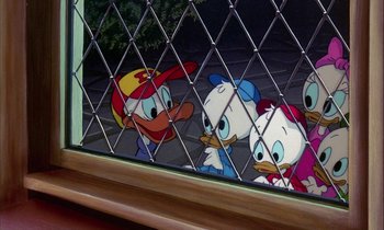 Movie still from “DuckTales the Movie: Treasure of the Lost Lamp” (1990), directed by Bob Hathcock – Two cartoon characters looking through a fence; Medium shot, High angle
