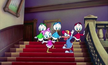 Movie still from “DuckTales the Movie: Treasure of the Lost Lamp” (1990), directed by Bob Hathcock – A group of cartoon characters standing on top of a set of stairs; Wide shot, High angle
