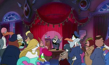 Movie still from “DuckTales the Movie: Treasure of the Lost Lamp” (1990), directed by Bob Hathcock – A crowd of people are gathered around a stage; Wide shot, High angle