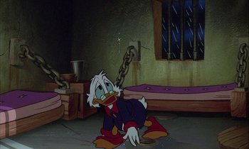 Movie still from “DuckTales the Movie: Treasure of the Lost Lamp” (1990), directed by Bob Hathcock – A cartoon of donald duck sitting on the ground; Wide shot, High angle