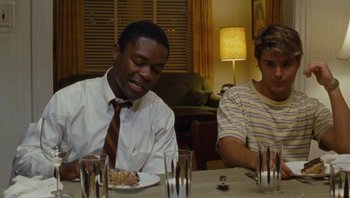 Movie still from “The Paperboy” (2012), directed by Lee Daniels – Two people sitting at a table with plates of food; Medium shot, Over the shoulder angle