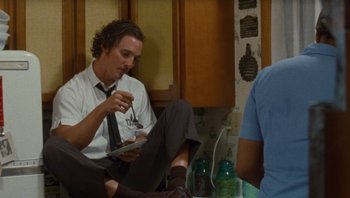 Movie still from “The Paperboy” (2012), directed by Lee Daniels – A man sitting on the kitchen floor eating a sandwich; Medium shot, High angle