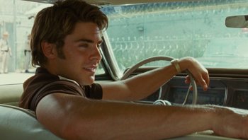 Movie still from “The Paperboy” (2012), directed by Lee Daniels – A man sitting in the driver's seat of a car; Close Up shot, Over the shoulder angle