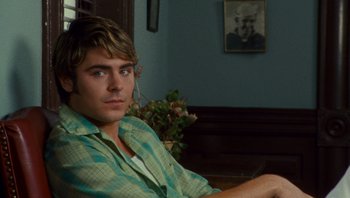 Movie still from “The Paperboy” (2012), directed by Lee Daniels – A man sitting in front of a wall with a plant; Close Up shot, Over the shoulder angle