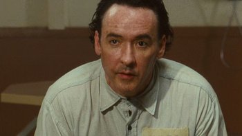 Movie still from “The Paperboy” (2012), directed by Lee Daniels – A person wearing a button up shirt; Close Up shot, Over the shoulder angle