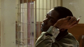 Movie still from “The Paperboy” (2012), directed by Lee Daniels – A man with his hand on his head in front of a jail cell; Close Up shot, High angle