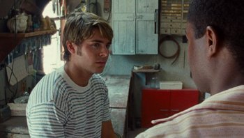 Movie still from “The Paperboy” (2012), directed by Lee Daniels – A young man talking to another man in a garage; Close Up shot, Over the shoulder angle