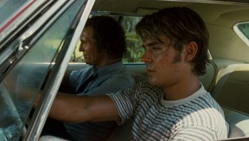 Movie still from “The Paperboy” (2012), directed by Lee Daniels – Two men sitting in the back seat of a car; Close Up shot, Over the shoulder angle