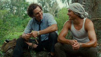 Movie still from “The Paperboy” (2012), directed by Lee Daniels – Two men sitting next to each other on the ground; Medium shot, Low angle