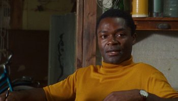 Movie still from “The Paperboy” (2012), directed by Lee Daniels – A man in a yellow shirt is looking at the camera; Close Up shot, Low angle