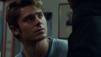 Movie still from “The Paperboy” (2012), directed by Lee Daniels – A young man looking at another man in a dark room; Close Up shot, Over the shoulder angle