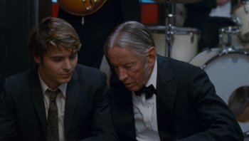 Movie still from “The Paperboy” (2012), directed by Lee Daniels – A man in a suit and a tie next to another man in a suit and a tie; Close Up shot, Over the shoulder angle