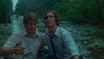 Movie still from “The Paperboy” (2012), directed by Lee Daniels – Two young men are standing next to each other; Medium shot, Low angle