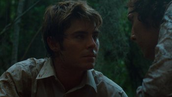 Movie still from “The Paperboy” (2012), directed by Lee Daniels – A young man in a tan shirt is talking to another man; Close Up shot, Over the shoulder angle