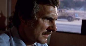 Movie still from “Duel” (1971), directed by Steven Spielberg – An older man with a mustache looking to his left; Close Up shot, Low angle