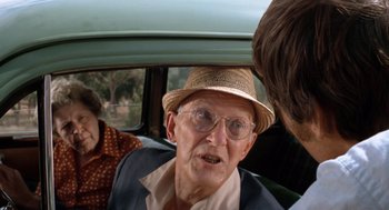 Movie still from “Duel” (1971), directed by Steven Spielberg – An old man wearing a straw hat in the back of a car; Close Up shot, Over the shoulder angle