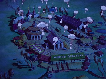 Movie still from “Dumbo” (1941), directed by Ben Sharpsteen – An aerial view of a town with a bunch of parachutists flying above it; Extreme Wide shot, High angle