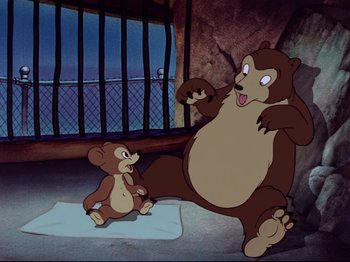 Movie still from “Dumbo” (1941), directed by Ben Sharpsteen – A bear and a mouse are in a cage; Wide shot, Overhead angle