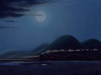 Movie still from “Dumbo” (1941), directed by Ben Sharpsteen – A train traveling on the tracks near a body of water at night; Extreme Wide shot, Low angle