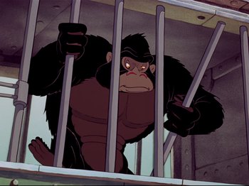 Movie still from “Dumbo” (1941), directed by Ben Sharpsteen – A gorilla standing behind bars in front of a building; Medium shot, Low angle