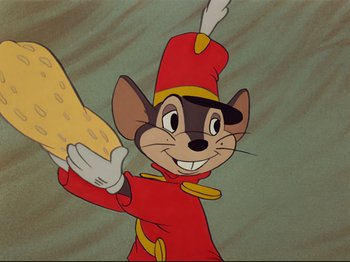Movie still from “Dumbo” (1941), directed by Ben Sharpsteen – A cartoon of a mouse holding a piece of cheese in his hand; Close Up shot, Over the shoulder angle