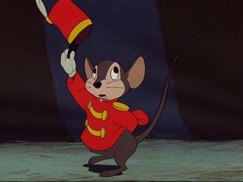 Movie still from “Dumbo” (1941), directed by Ben Sharpsteen – A mouse in a red outfit holding a red hat; Medium shot, Low angle