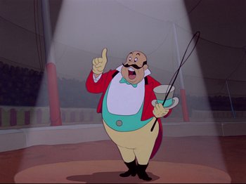 Movie still from “Dumbo” (1941), directed by Ben Sharpsteen – A man in a circus ring holding a whip and pointing up; Medium shot, Low angle