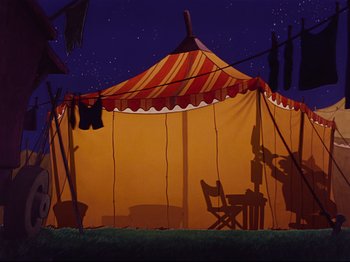 Movie still from “Dumbo” (1941), directed by Ben Sharpsteen – An orange and red tent with a chair and clothes hanging on a clothesline; Wide shot, Low angle