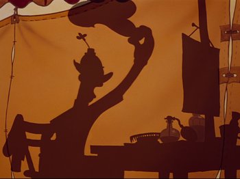 Movie still from “Dumbo” (1941), directed by Ben Sharpsteen – A shadow of a person holding something in their hand; Medium shot, Low angle